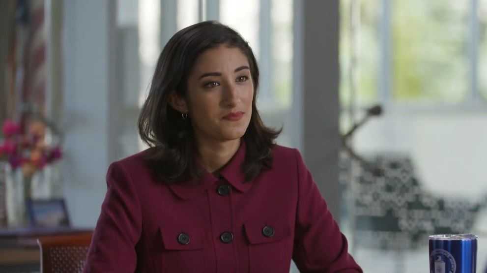 Dark haired women in red jacket.